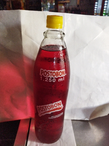 Gaseosa postobon 1.25LT vidrio kola