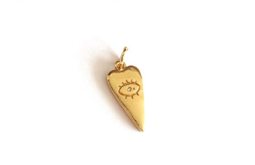 #17…Un Dije corazon con ojo pestaña, con baño de oro y zircones.